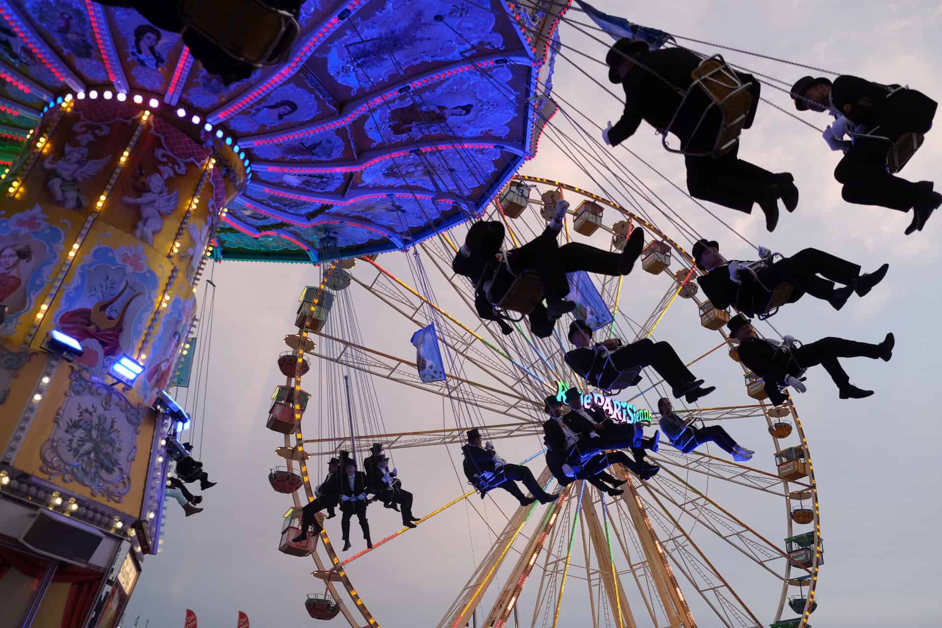 Carrousel lors de la fête des tireurs de Hanovre 2025 avec des passagers en l'air.