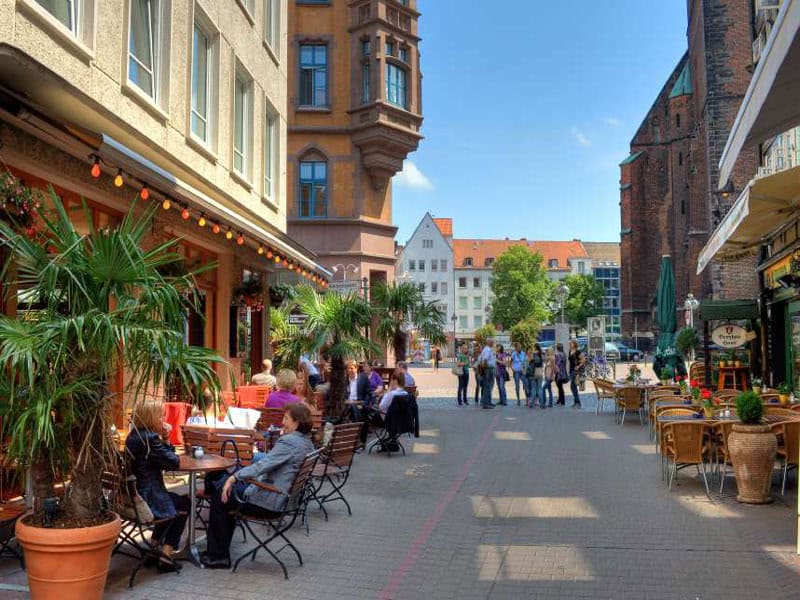 Altstadt Hannover mit Straßencafé, historischen Gebäuden und lebendiger Atmosphäre.